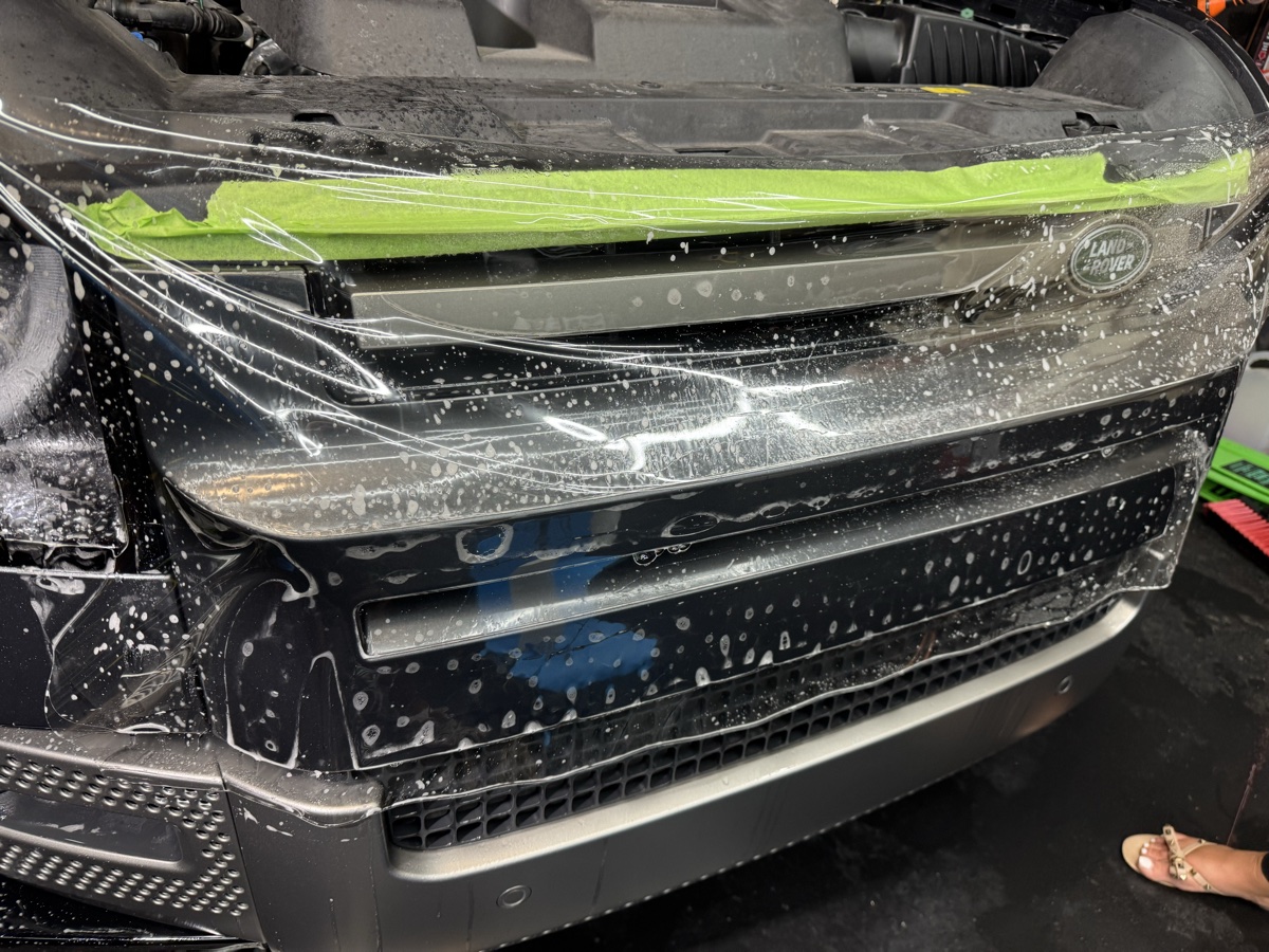 LLumar Valor PPF being installed on Land Rover front bumper at CBA Detailing Dumont NJ